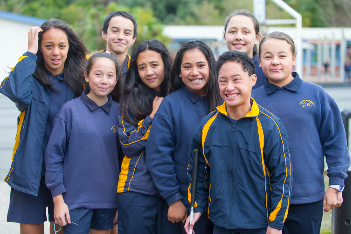 Boston standing outside with seven school friends.
