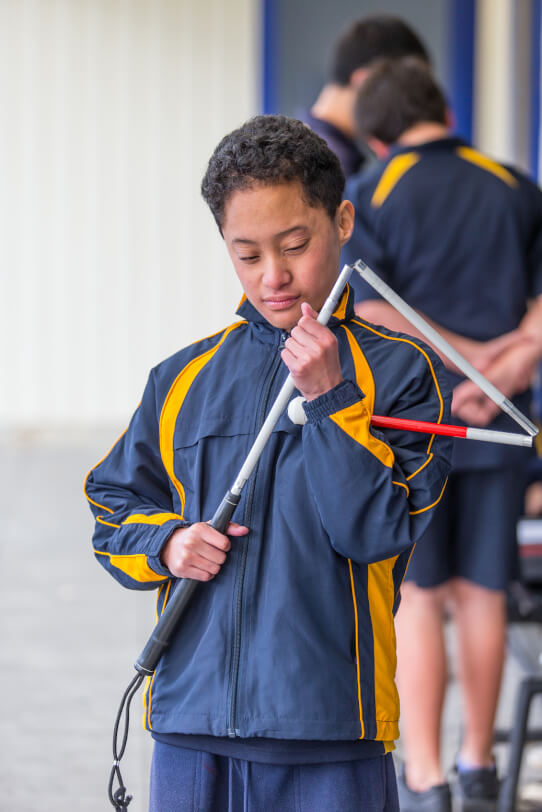 Boston holding his partially folded cane.