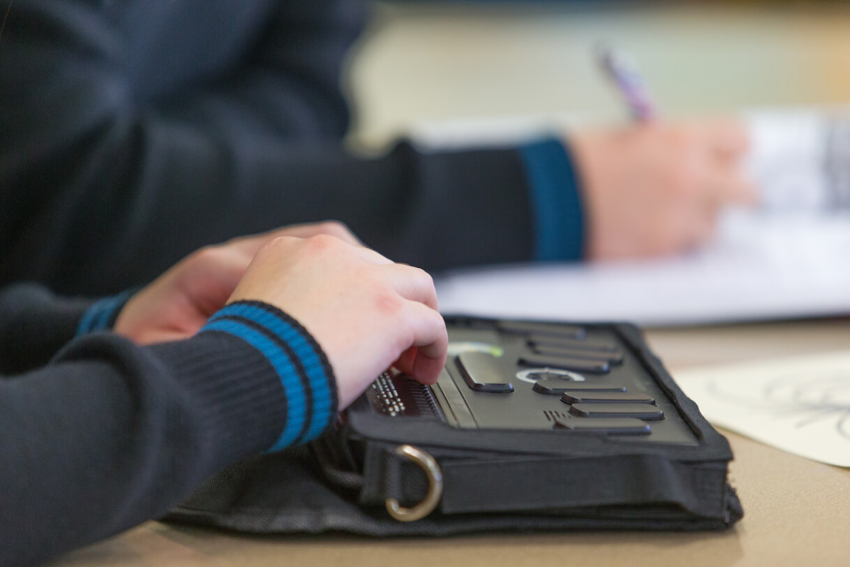 Hands resting on BrailleNote.