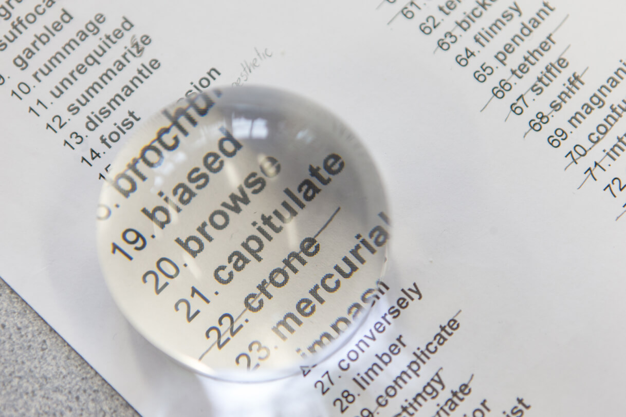 Dome magnifier enlarges word on a page.