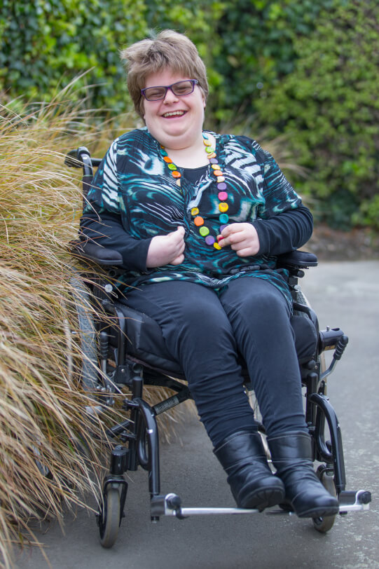 Katelyn sitting outside in her chair.