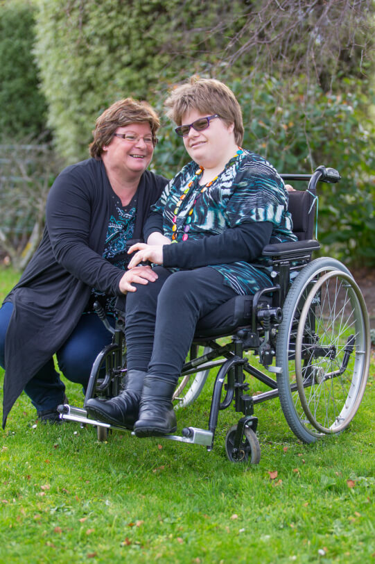 Katelyn sitting outside with her mum.