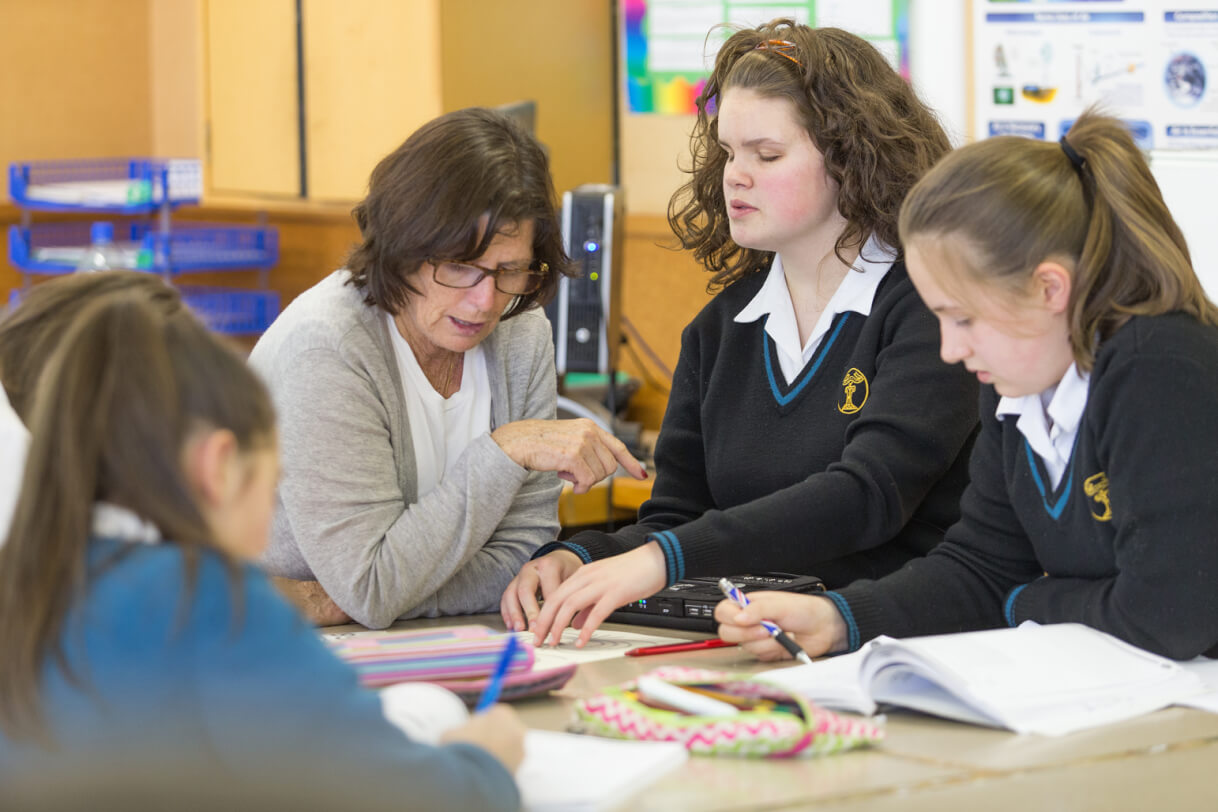 Renee and her RTV sitting in class with her peers.