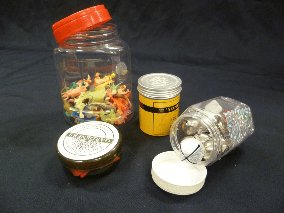 Four jars and tins of different sizes with screw tops.