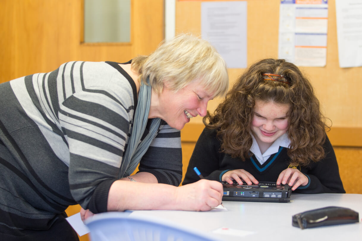 Renee and her teacher in the classroom.