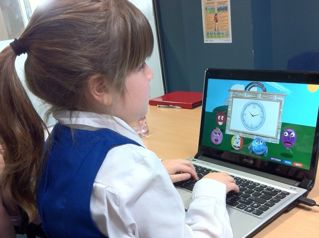 Young girl who is blind using the keyboard while playing with Ballyland